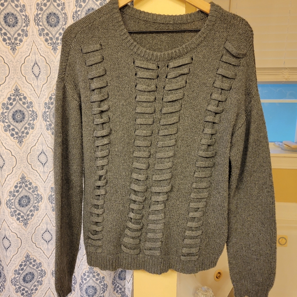Sweater with woven cuts